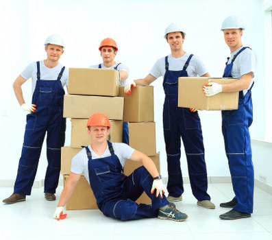 Local removal service loading furniture near Soho commercial premises
